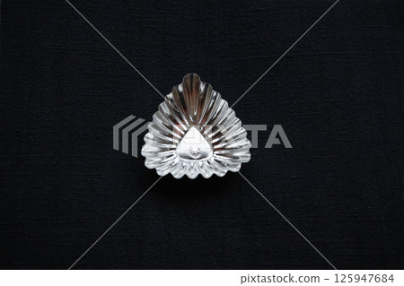 Triangular tray on hand-spun indigo-dyed cloth, horizontal composition 125947684