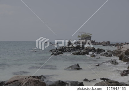 A Serene Coastal Landscape Featuring a Rocky Shoreline and Overcast, Cloudy Skies Above A Serene Coastal Landscape Featuring a Rocky Shoreline and Overcast, Cloudy Skies Above 125948463
