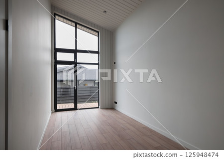 A Modern Minimalist Room Featuring Large Window Views That Enhance the Aesthetic Ambiance 125948474