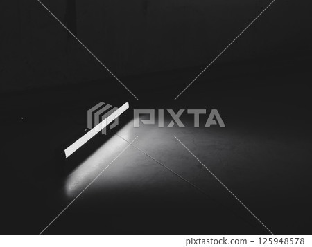 A Minimalist Light Beam Illuminating a Dark Floor in an Abstract and Aesthetic Way A Minimalist Light Beam Illuminating a Dark Floor in an Abstract and Aesthetic Way 125948578