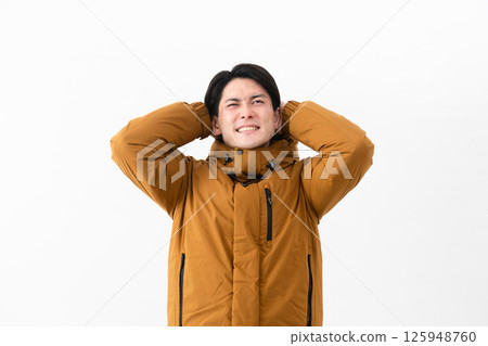 Young man wearing a down coat Young man wearing a down coat 125948760