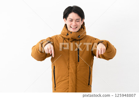 Young man wearing a down coat 125948807
