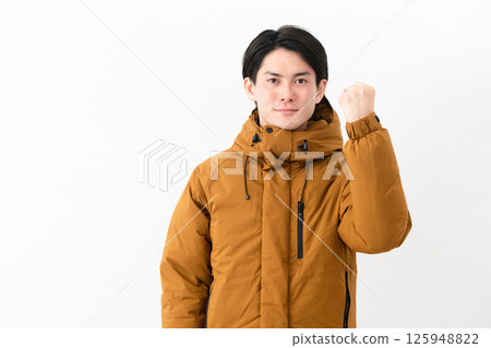 Young man wearing a down coat Young man wearing a down coat 125948822