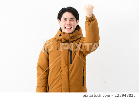 Young man wearing a down coat 125948823