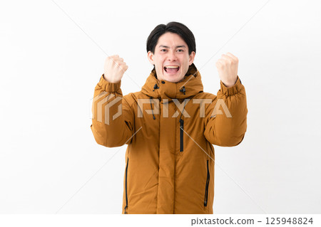 Young man wearing a down coat Young man wearing a down coat 125948824