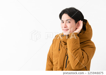Young man wearing a down coat 125948875