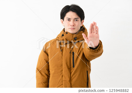 Young man wearing a down coat Young man wearing a down coat 125948882