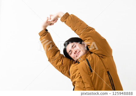 Young man wearing a down coat Young man wearing a down coat 125948888