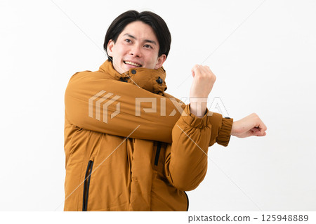 Young man wearing a down coat Young man wearing a down coat 125948889