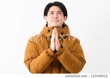 Young man wearing a down coat Young man wearing a down coat 125948918