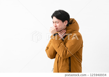 Young man wearing a down coat Young man wearing a down coat 125948934