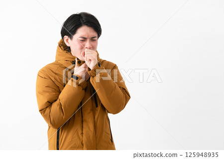 Young man wearing a down coat 125948935