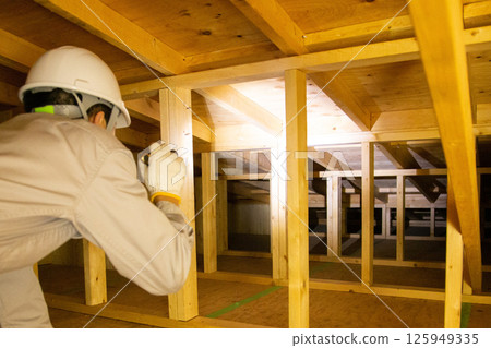 A trader who works in the attic of a house 125949335