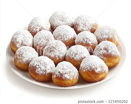 Delicious sufganiyot doughnuts for Hanukkah celebration topped with powdered sugar on white plate 125950202