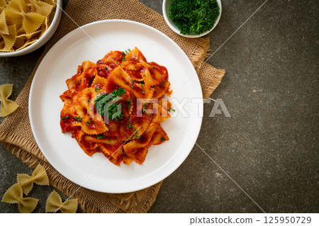 farfalle pasta in tomato sauce with parsley farfalle pasta in tomato sauce with parsley 125950729