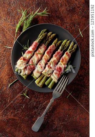 Grilled green asparagus wrapped in bacon. Grilled green asparagus wrapped in bacon. 125951192