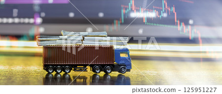 Logistics truck carrying money bundles with stock market graph 125951227