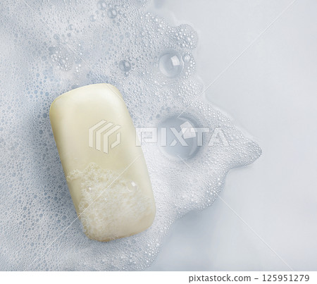 White soap bar and suds on a white background. 125951279