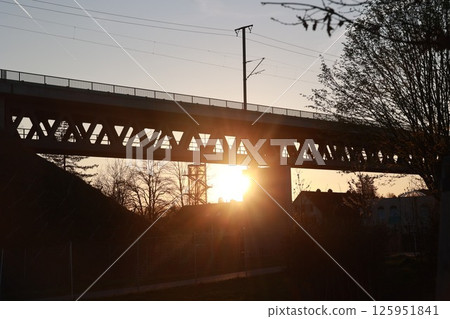 A bridge with a sun shining on it 125951841