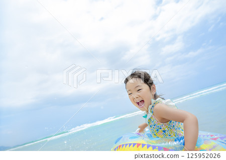 girl playing in the summer sea girl playing in the summer sea 125952026