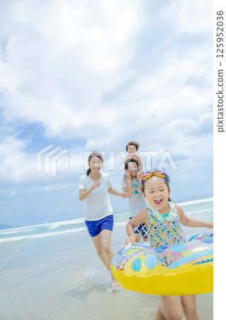A family of four playing in the summer sea A family of four playing in the summer sea 125952036