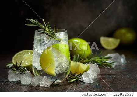Gin and tonic cocktail made with dry gin, tonic water, lime, and ice. Gin and tonic cocktail made with dry gin, tonic water, lime, and ice. 125952553