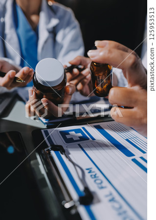 Male and female doctors are having a meeting in a hospital room. Male and female doctors are having a meeting in a hospital room. 125953513