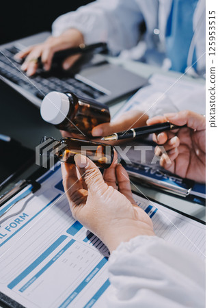 Male and female doctors are having a meeting in a hospital room. Male and female doctors are having a meeting in a hospital room. 125953515