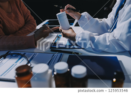 Specialized doctor is explaining taking medicine to a patient. Health and medicine consultation. Specialized doctor is explaining taking medicine to a patient. Health and medicine consultation. 125953546
