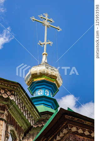 Golden cross of Holy Trinity Cathedral in Karakol city Golden cross of Holy Trinity Cathedral in Karakol city 125953598
