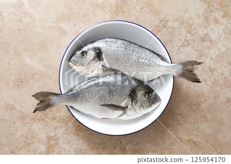 Fresh raw sea bream fish or dorado fish, top view Fresh raw sea bream fish or dorado fish, top view 125954170