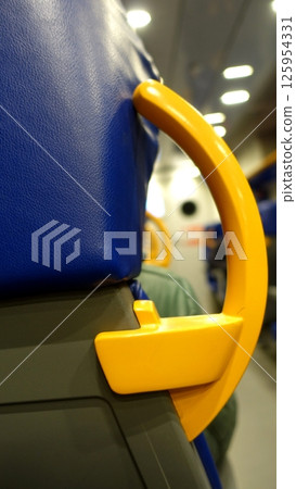 A yellow handle to help you balance while standing in a train. A yellow handle to help you balance while standing in a train. 125954331