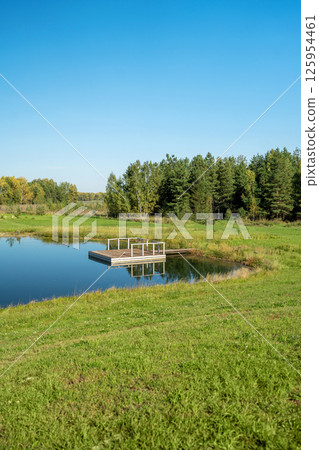 A Serene and Tranquil Lakeside View That Is Completely Surrounded by Lush Greenery A Serene and Tranquil Lakeside View That Is Completely Surrounded by Lush Greenery 125954461