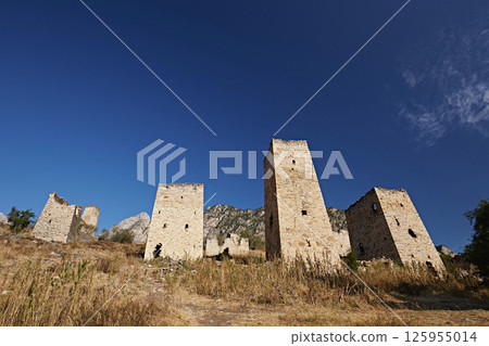 Mountain landscape: towers in the Caucasus, medieval town against blue sky 125955014