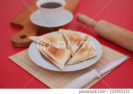 a neatly plated pair of toasted sandwich triangles on a white plate a neatly plated pair of toasted sandwich triangles on a white plate 125955231