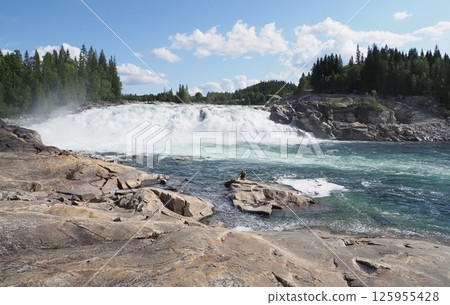 Rocks and Laksforsen waterfall at Vefsna river in Grane town in Norway Rocks and Laksforsen waterfall at Vefsna river in Grane town in Norway 125955428