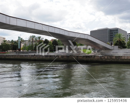 Modern buildings and footbridge at Nervion river in European Bilbao city in Spain Modern buildings and footbridge at Nervion river in European Bilbao city in Spain 125955436