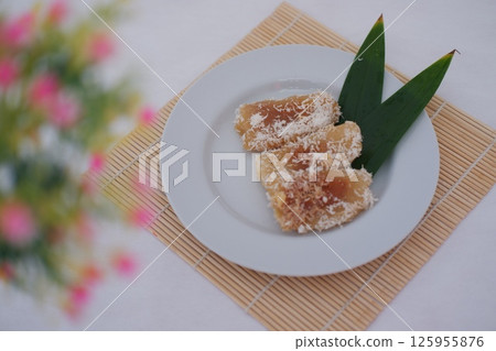 a traditional Indonesian snack known as "getuk lindri" or steamed cassava topped with grated coconut a traditional Indonesian snack known as "getuk lindri" or steamed cassava topped with grated coconut 125955876