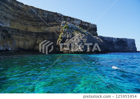 Crystal lagoon and cliffs on European Comino island in Malta Crystal lagoon and cliffs on European Comino island in Malta 125955954