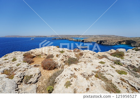 Yacht and blue lagoon at European Comino island in Malta Yacht and blue lagoon at European Comino island in Malta 125956527