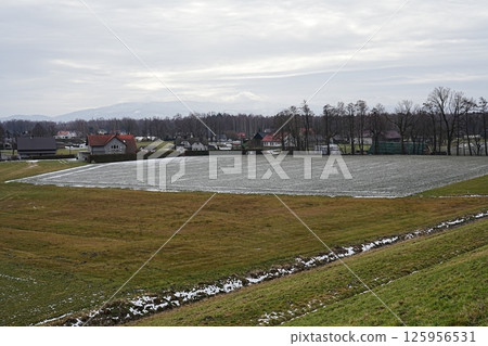 Frozen farmland in Beskid Mountains near Goczalkowice reservoir in Poland 125956531