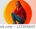 Stylish young woman confident pose modern attitude on vibrant orange circular background 125956605
