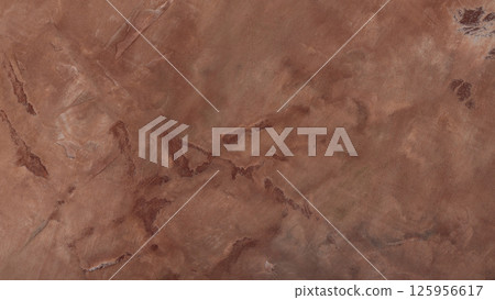Rustic Clay Wall Texture with Warm Earthtone Plaster for Mediterranean Interior Design 125956617