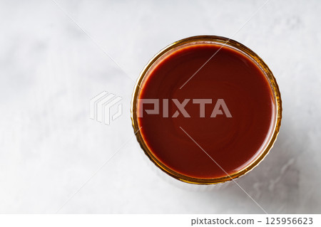 Cocoa Drink in Gold Rimmed Glass on Gray Background, Copy Space, Top View 125956623