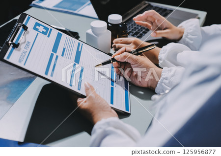 Male and female doctors are having a meeting in a hospital room. 125956877