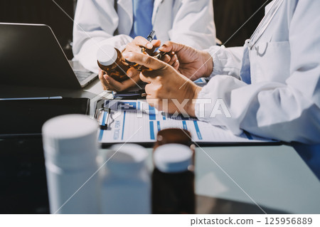 Male and female doctors are having a meeting in a hospital room. 125956889