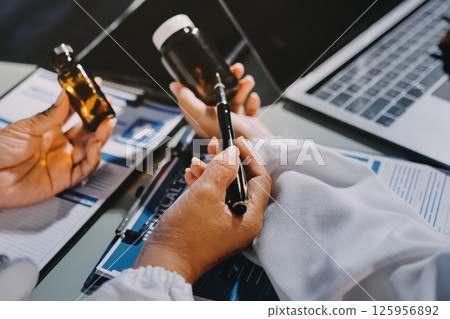 Male and female doctors are having a meeting in a hospital room. Male and female doctors are having a meeting in a hospital room. 125956892