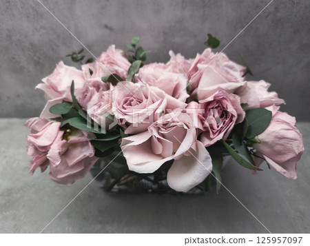 Delicate pink roses forming an elegant bridal bouquet on gray background wallpaper copy space Delicate pink roses forming an elegant bridal bouquet on gray background wallpaper copy space 125957097