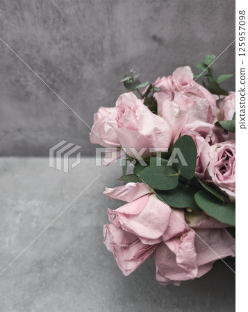 Delicate pink roses and eucalyptus wedding bouquet on gray background wallpaper copy space 125957098