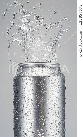 Refreshing silver aluminum energy drink can with mist and droplets emphasizing pure refreshment 125957572